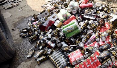 बिहार में शराब से मौत के बाद शराब की बोतलों को किया गया नष्ट।