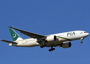 Manchester International Airport, England, United Kingdom - March 11, 2014. Pakistan International Airlines Boeing 777-200 on approach to land.