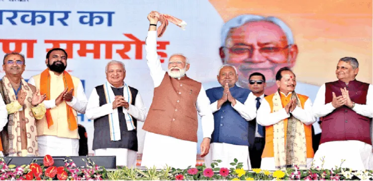 शपथग्रहण के बाद गमछा घुमाकर लोगों का अभिवादन करते प्रधानमंत्री नरेंद्र मोदी। साथ में हैं नीतीश कुमार, राज्यपाल आरिफ मोहम्मद खान और अन्य मंत्री